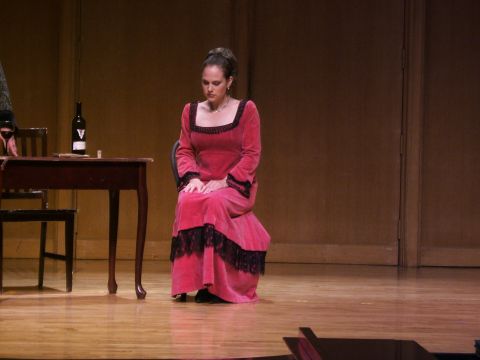 1996 Ford Probe - A woman in a period costume sits on stage next to a table with a wine bottle.