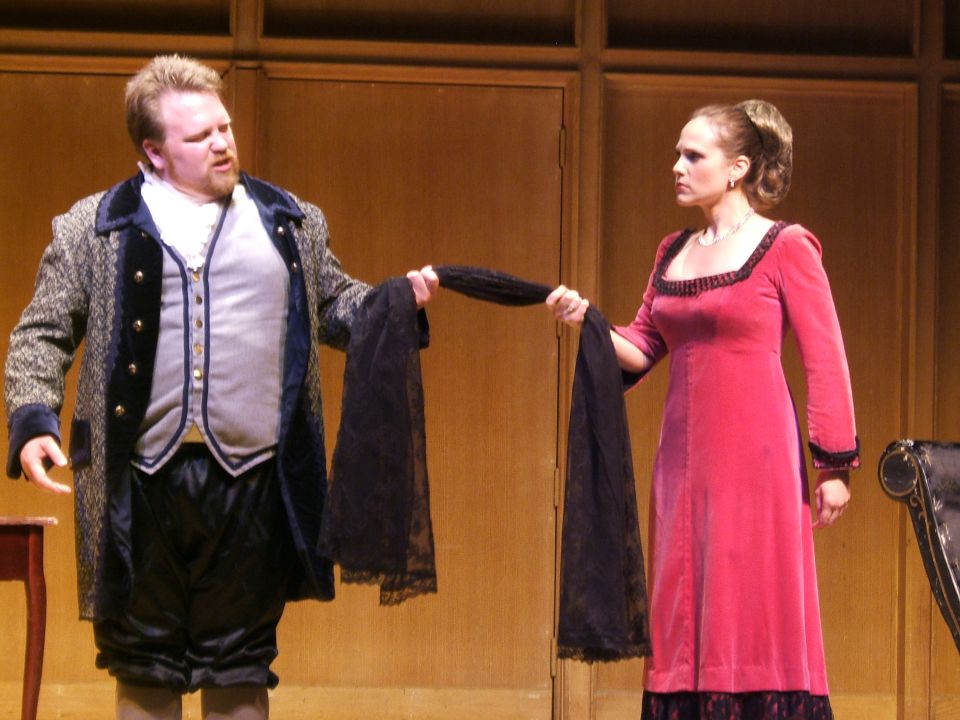 Stage actors holding a black scarf