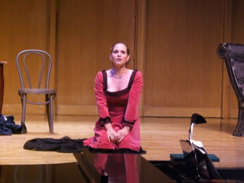 1996 Ford Probe - A woman in a red dress kneels on a stage, with theatrical props around her.