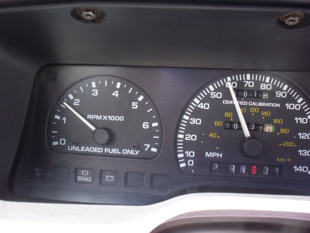 Ford tachometer and speedometer cluster, odometer reads 000037, Unleaded Fuel Only