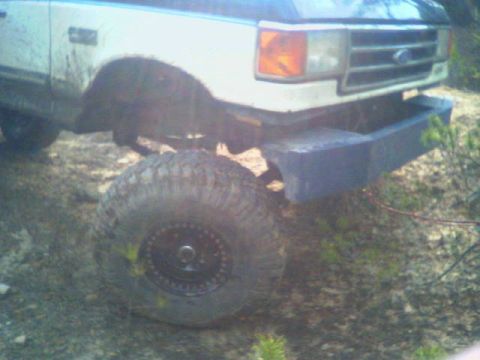 1991 Ford F-150 - This 1991 Ford F-150 features a custom bumper and large off-road tires, suggesting it's built for terrain.