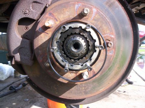 1986 Ford Bronco - Front wheel hub and brake assembly, showing wear and rust.