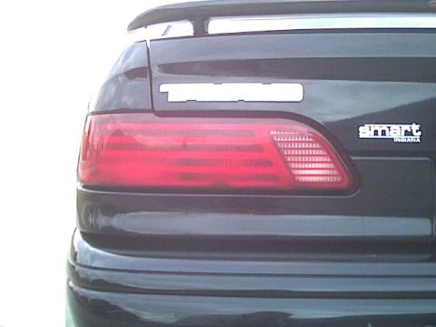 1993 Ford Taurus - Close-up of a 1993 Ford Taurus taillight and rear badging.