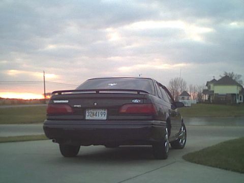 1993 Ford Taurus - Rear view of a 1993 Ford Taurus sedan parked outdoors during sunset.
