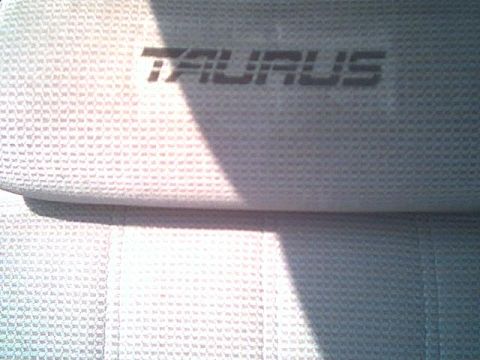 1993 Ford Taurus - The fabric of a car seat shows the embossed 'TAURUS' name.