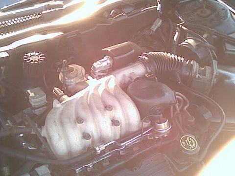 1993 Ford Taurus - Close-up view of an engine bay, showing various mechanical parts and wiring.