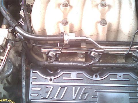 1993 Ford Taurus - Close-up view of an engine component with "3.0 V6" labeling.
