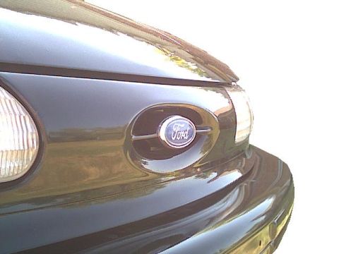 1993 Ford Taurus - The Ford emblem is clearly visible on the front grille of the vehicle.