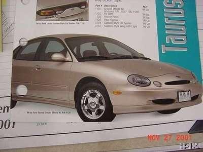 1993 Ford Taurus - This image shows a gold Ford Taurus with aftermarket body kit parts, indicating a 1996 model year.