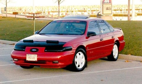 1993 Ford Taurus - This 1993 Ford Taurus sedan is shown from a three-quarter front view, a black bra and a custom license plate.