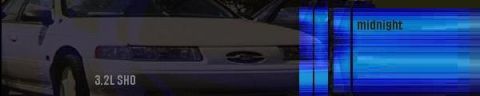 1993 Ford Taurus - The front of a white 1993 Ford Taurus is visible, with "3.2L SHO" text on the grille.