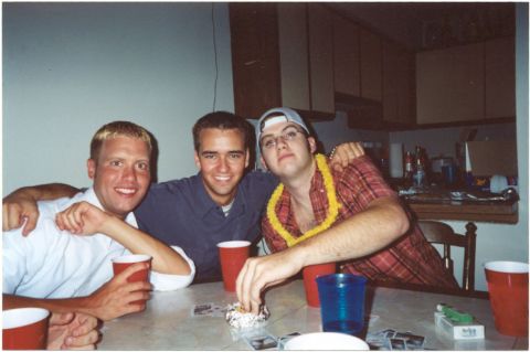 1993 Ford Taurus - Friends gather around a table, enjoying drinks and company in a casual indoor setting.