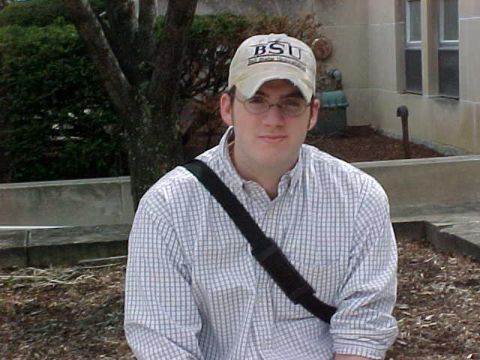 1993 Ford Taurus - A man wearing a BSU baseball cap and glasses is seen outdoors.