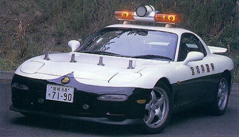 1993 Ford Taurus - A modified sports car serves as a police vehicle, equipped with emergency lights and spotlights.