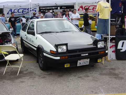 1993 Ford Taurus - This 1985 Toyota Corolla AE86 Trueno is displayed at an event with tents in the background.
