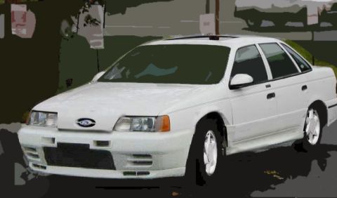 1993 Ford Taurus - This white 1993 Ford Taurus sedan is shown from a three-quarter front view.
