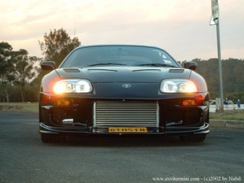 1993 Ford Taurus - Modified Toyota Supra with prominent aftermarket intercooler and custom plate.