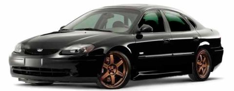1993 Ford Taurus - This black sedan's body style suggests a model year around 2000, not 1993.