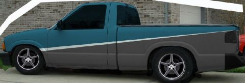 1993 Ford Taurus - A side view of a modified pickup truck with a distinctive two-tone paint scheme and custom wheels.