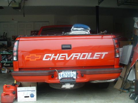 1993 Ford Taurus - Rear view of a red Chevrolet pickup truck, likely from the early to mid-1990s, with a visible license plate.