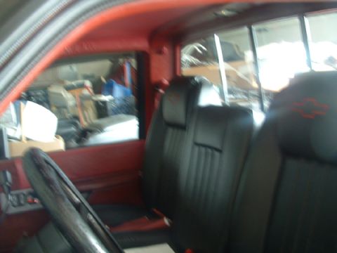 1993 Ford Taurus - Interior of a pickup truck, showing the seats and steering wheel. A Chevrolet logo is visible on the headrest.