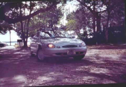 1998 Ford Taurus - This 1998 Ford Taurus SE is seen parked in a wooded area near the water.