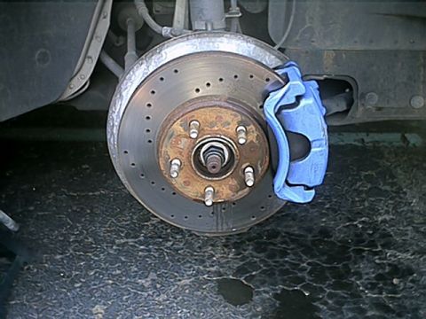 1998 Ford Taurus - Front passenger side shot of the cross-drilled rotors and blue caliper.