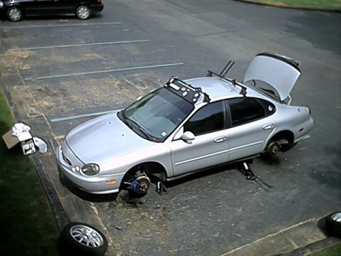 1998 Ford Taurus - Picture of the driver side jacked up during tire rotation.