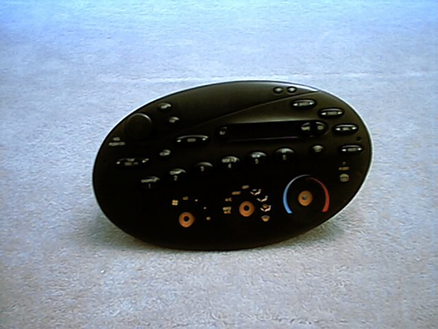 Black oval HVAC climate control faceplate on carpet