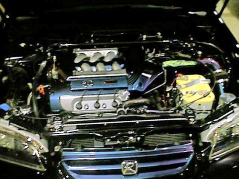 1998 Ford Taurus - The engine bay of a car is shown with various components and modifications.