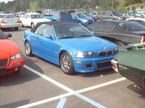 1998 Ford Taurus - Blue BMW M3 convertible in a parking lot with other cars.