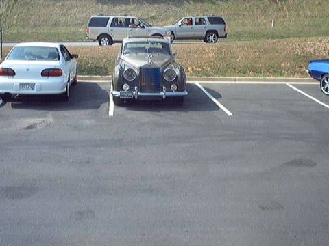 1998 Ford Taurus - A vintage Rolls-Royce is parked in a lot with other vehicles visible.