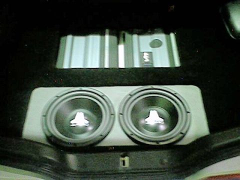 1998 Ford Taurus - The trunk of a car is shown with custom audio equipment installed, including subwoofers and amplifiers.