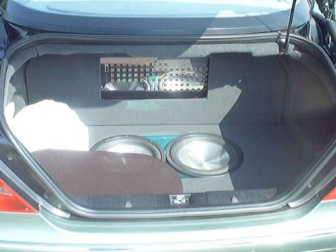 1998 Ford Taurus - Custom car trunk setup with subwoofers and amplifier visible.