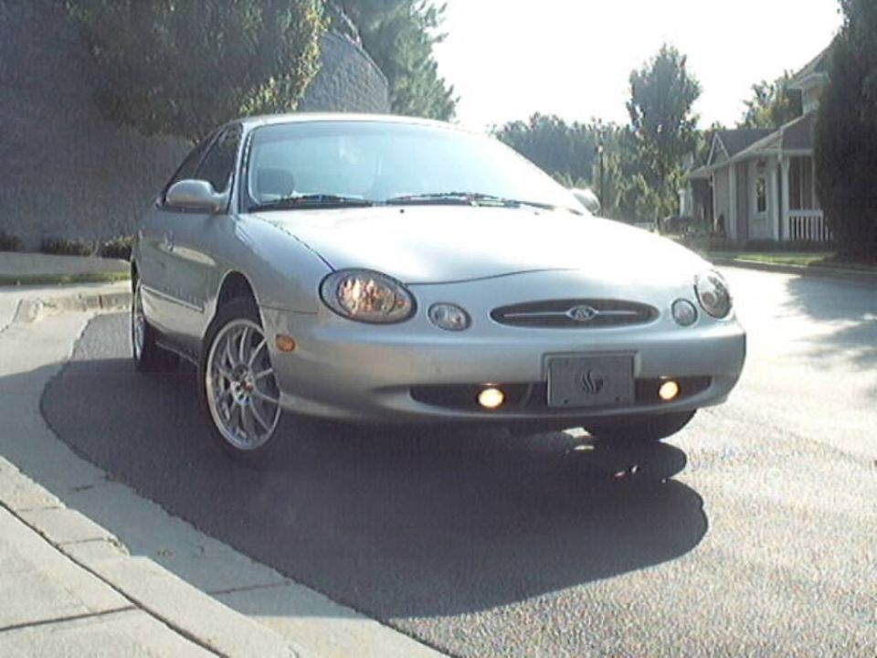 Silver sedan parked on a residential street, front view
