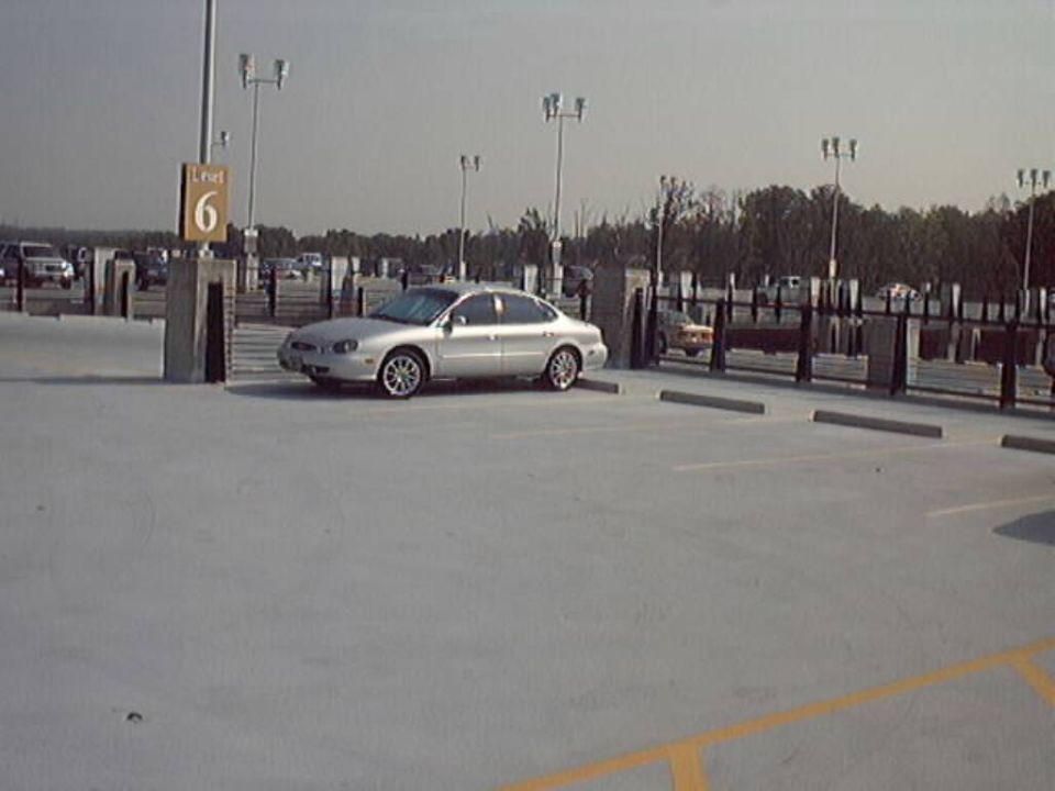 Silver 1998 Ford Taurus parked in a lot, 3q front view