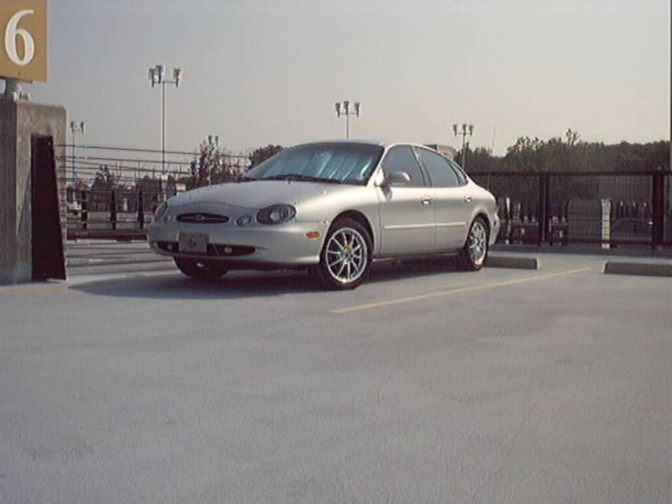 Silver 1998 Ford Taurus sedan parked in a lot