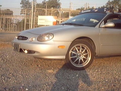1998 Ford Taurus - A silver 1998 Ford Taurus sedan is shown from the front three-quarter view, parked outdoors.
