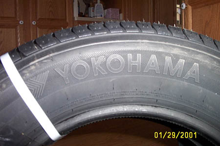 1993 Ford Taurus - Close-up of a Yokohama tire, showing the brand name and tread pattern.
