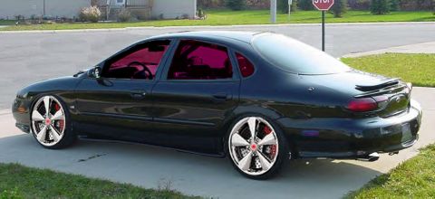 1993 Ford Taurus - SHO on 20's with red tint and some crazy calipers.