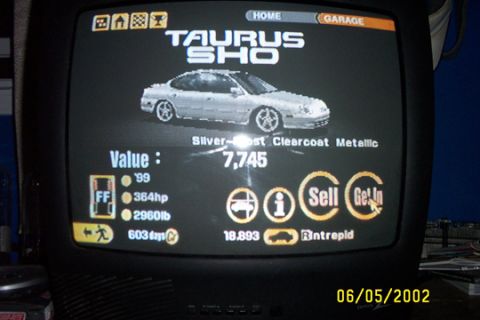 1993 Ford Taurus - A digital display shows a car's details, including its value and performance metrics.