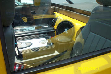 1993 Ford Taurus - Custom audio system installed in a yellow car interior, subwoofers and amplifiers.