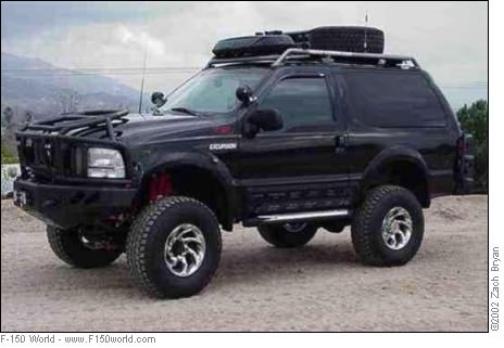 1990 Ford Bronco - This modified Ford Excursion features an aggressive front bumper and a roof-mounted spare tire.