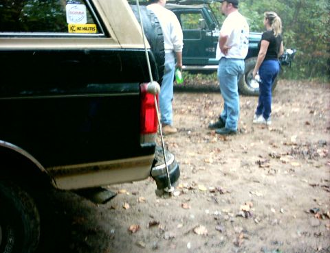 1990 Ford Bronco - Rear view of a 1990 Ford Bronco, with people and another vehicle in the background.