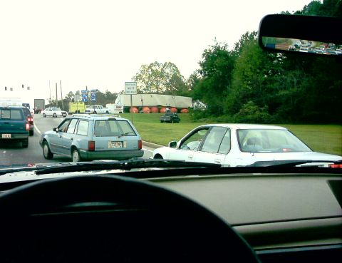 1990 Ford Bronco - Traffic jam on the highway with multiple vehicles visible.