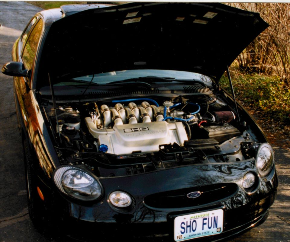 Black Ford Taurus with hood up showing SHO engine and Missouri 'SHO FUN' plate