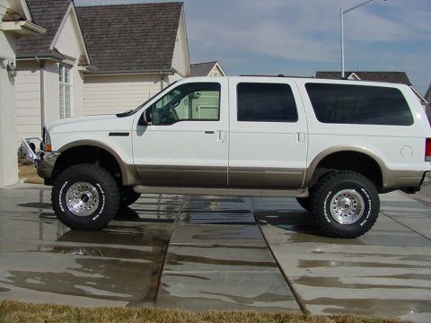 2002 Ford Excursion - This white Ford Excursion SUV is shown from the side, a two-tone paint scheme and large wheels.