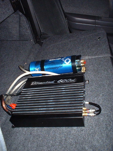 2000 Ford Taurus - Car amplifier and capacitor installed in the trunk of a vehicle.