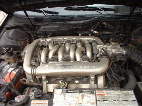 2000 Ford Taurus - Close-up of a Ford SHO V6 engine, showing the intake manifold and battery.