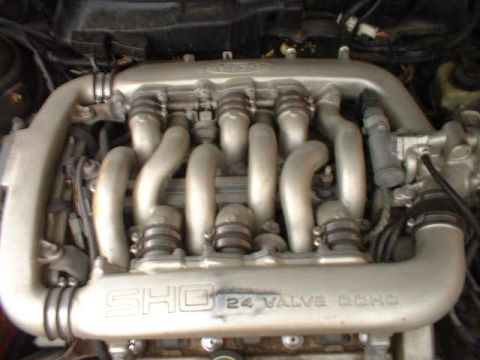 2000 Ford Taurus - The intake manifold of a Ford SHO engine is visible, showing "SHO 24 VALVE DOHC" markings.